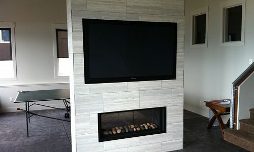 Marquis Infinite See Through. This linear gas fireplace was installed for a custom home by Edgecombe Builders of Kelowna. The fireplace is ideal for the placement of the 60" flat panel T.V. above it. The fireplace can have different media including rocks, twigs or glass media. This fireplace is made in Canada.