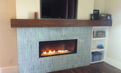 "Sleek & Simple" Cosmo fireplace by Heat & Glo installed into a bedroom with a television above. 